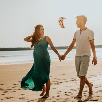 couple holding hands on beach